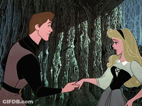 A Man And A Woman Are Standing Next To Each Other And The Woman Is Holding The Man 'S Hand GIF