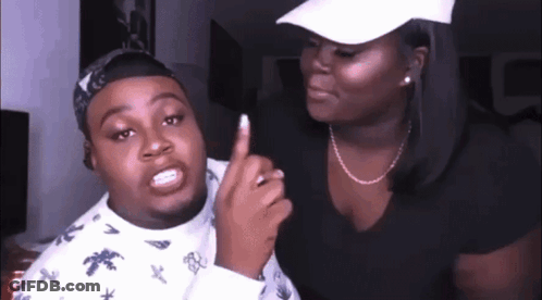 A Man And A Woman Are Standing Next To Each Other And The Woman Is Pointing At The Man 'S Finger . GIF
