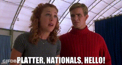 A Man And A Woman Are Standing Next To Each Other And The Woman Is Saying `` Platter , Nationals , Hello '' . GIF