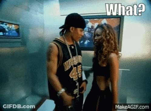 A Man And A Woman Are Standing Next To Each Other And The Woman Is Wearing A Jersey With The Number 45 On It GIF