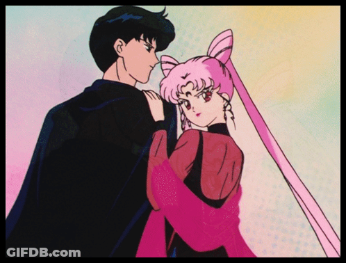 A Man And A Woman Are Standing Next To Each Other And The Woman Is Wearing A Pink Dress GIF