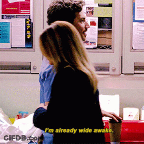 A Man And A Woman Are Standing Next To Each Other And The Woman Says I 'M Already Wide Awake GIF