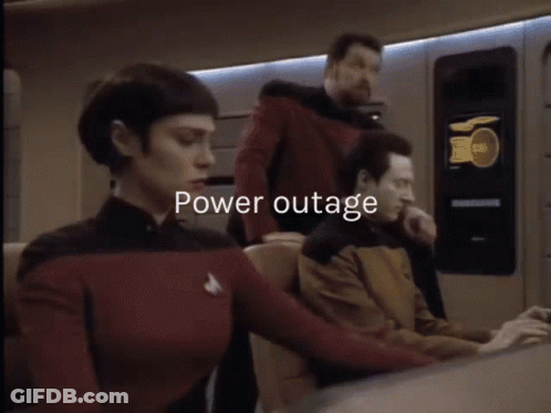 A Man And A Woman Are Standing Next To Each Other And The Words Power Outage Are Displayed Above Them GIF
