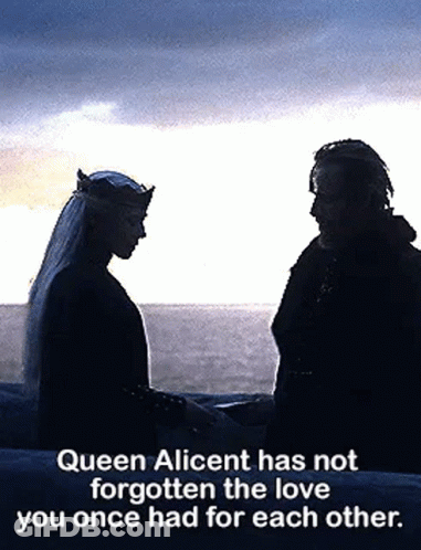 A Man And A Woman Are Standing Next To Each Other Holding Hands . GIF
