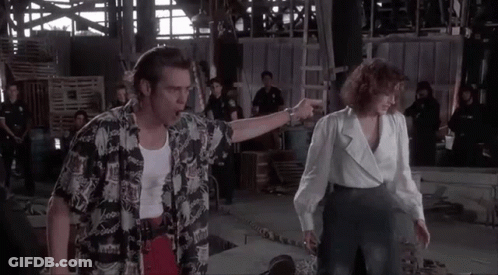 A Man And A Woman Are Standing Next To Each Other In A Building . GIF