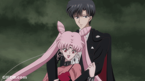 A Man And A Woman Are Standing Next To Each Other In A Dark Room GIF