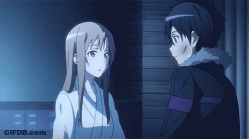 A Man And A Woman Are Standing Next To Each Other In A Dark Room . GIF