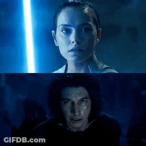 A Man And A Woman Are Standing Next To Each Other In A Dark Room With A Blue Light Behind Them . GIF