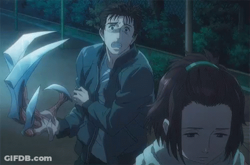 A Man And A Woman Are Standing Next To Each Other In A Dark Room With A Monster Behind Them . GIF