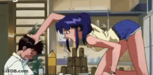 A Man And A Woman Are Standing Next To Each Other In A Kitchen And The Woman Is Holding The Man 'S Head . GIF