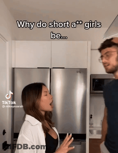A Man And A Woman Are Standing Next To Each Other In A Kitchen With The Caption Why Do Short A *** Girls Be GIF