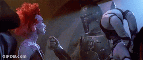A Man And A Woman Are Standing Next To Each Other In A Room . GIF