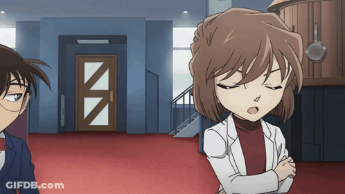 A Man And A Woman Are Standing Next To Each Other In A Room GIF