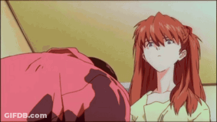 A Man And A Woman Are Standing Next To Each Other In A Room . GIF
