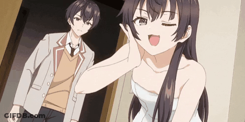 A Man And A Woman Are Standing Next To Each Other In A Room . GIF