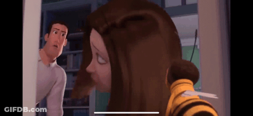 A Man And A Woman Are Standing Next To Each Other In A Room . The Woman Is Wearing A Bee Costume . GIF