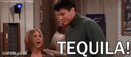 A Man And A Woman Are Standing Next To Each Other In A Room With The Word Tequila On The Screen . GIF