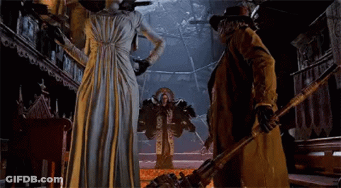 A Man And A Woman Are Standing Next To Each Other In A Room . GIF