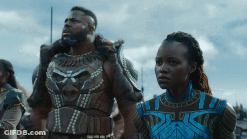 A Man And A Woman Are Standing Next To Each Other In A Scene From A Movie GIF