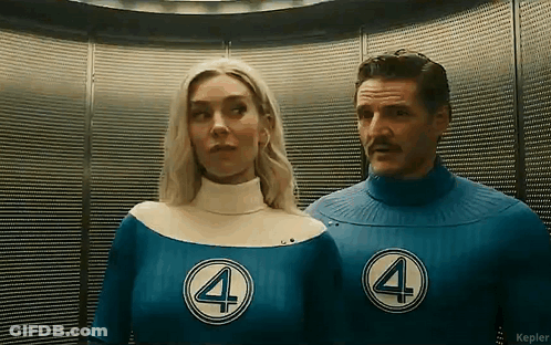 A Man And A Woman Are Standing Next To Each Other In An Elevator Wearing Superhero Costumes . GIF