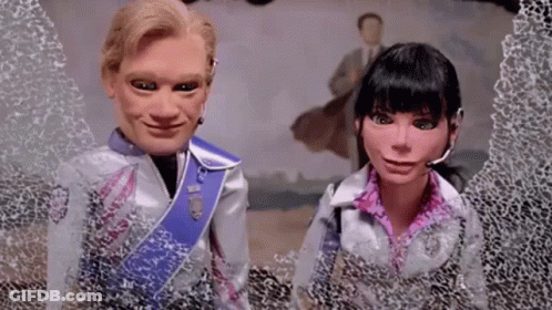 A Man And A Woman Are Standing Next To Each Other In Front Of A Broken Window . GIF