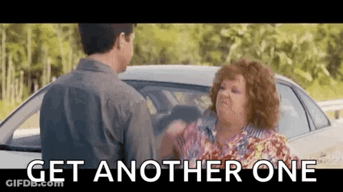 A Man And A Woman Are Standing Next To Each Other In Front Of A Car And The Woman Is Yelling At The Man . GIF