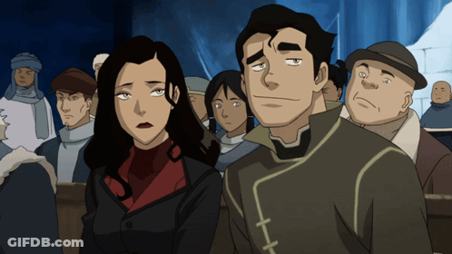 A Man And A Woman Are Standing Next To Each Other In Front Of A Crowd GIF