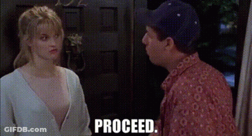A Man And A Woman Are Standing Next To Each Other In Front Of A Door And The Words Proceed Are Visible . GIF