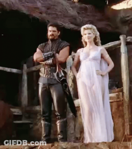 Man And Woman Standing Next To Fence GIF