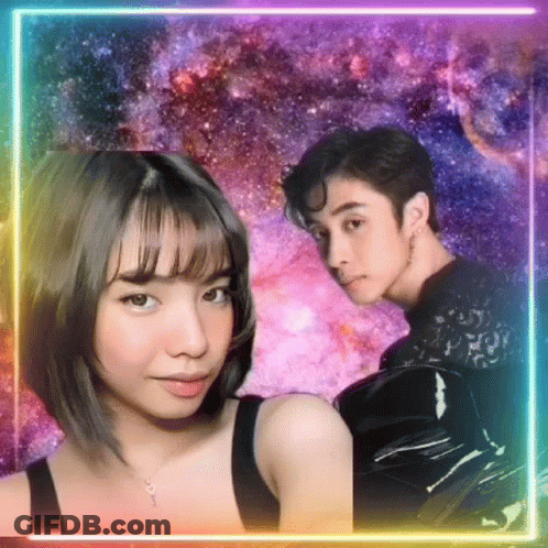 A Man And A Woman Are Standing Next To Each Other In Front Of A Galaxy Background . GIF
