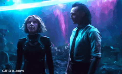 A Man And A Woman Are Standing Next To Each Other In Front Of A Purple Background . GIF