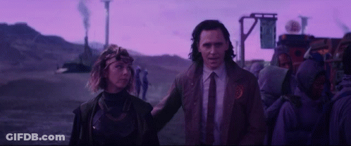 A Man And A Woman Are Standing Next To Each Other In Front Of A Purple Sky . GIF
