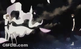 A Man And A Woman Are Standing Next To Each Other In The Dark . GIF