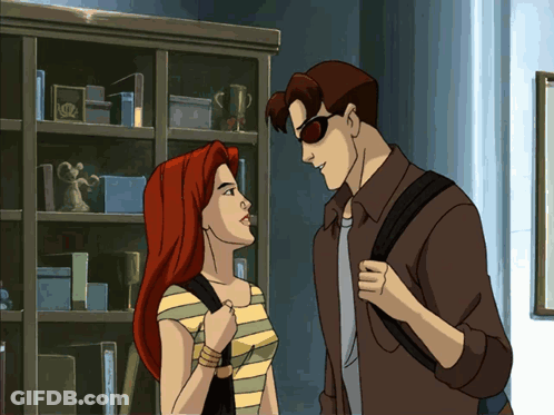 A Man And A Woman Are Standing Next To Each Other GIF