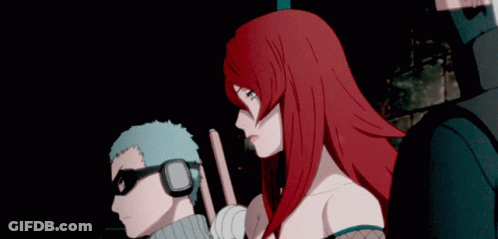 A Man And A Woman Are Standing Next To Each Other GIF