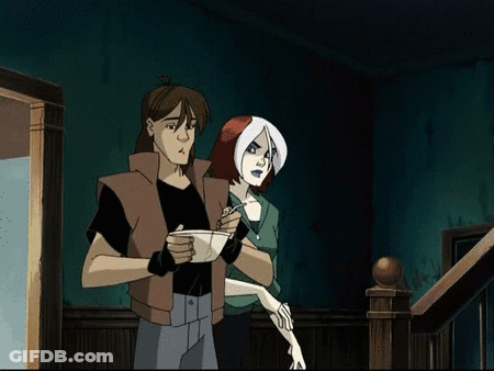 A Man And A Woman Are Standing Next To Each Other GIF
