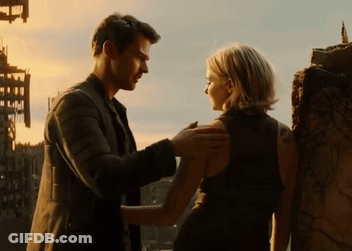 A Man And A Woman Are Standing Next To Each Other Looking At Each Other GIF