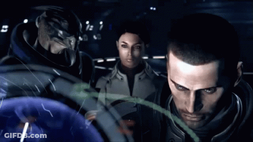 A Man And A Woman Are Standing Next To Each Other Looking At Something GIF