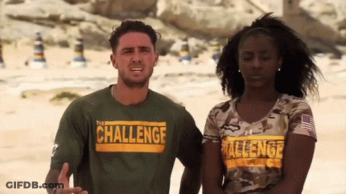 A Man And A Woman Are Standing Next To Each Other On A Beach Wearing Shirts That Say Challenge . GIF