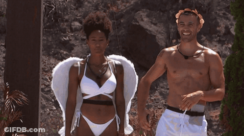 A Man And A Woman Are Standing Next To Each Other On A Deck GIF