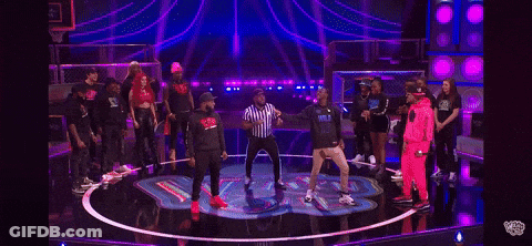 A Man And A Woman Are Standing Next To Each Other On A Stage . The Man Is Wearing A Hoodie That Says Wild GIF