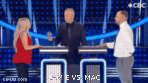 A Man And A Woman Are Standing Next To Each Other On A Stage With The Words Jamie Vs Mac Written On The Screen . GIF
