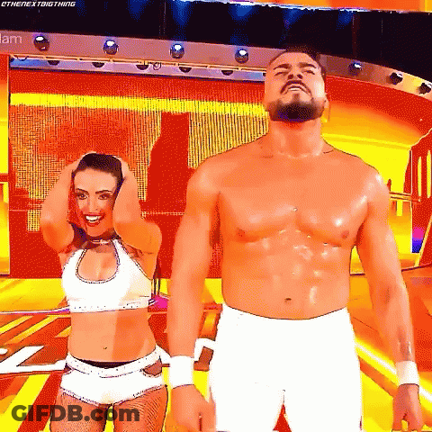 A Man And A Woman Are Standing Next To Each Other On A Stage With Their Hands In Their Hair . GIF