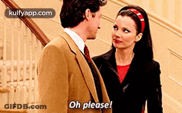 A Man And A Woman Are Standing Next To Each Other On A Staircase . GIF