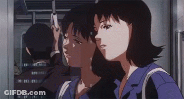 A Man And A Woman Are Standing Next To Each Other On A Train . GIF