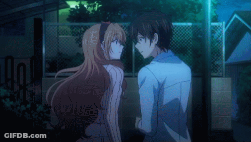 A Man And A Woman Are Standing Next To Each Other GIF