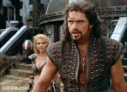 A Man And A Woman Are Standing Next To Each Other . GIF