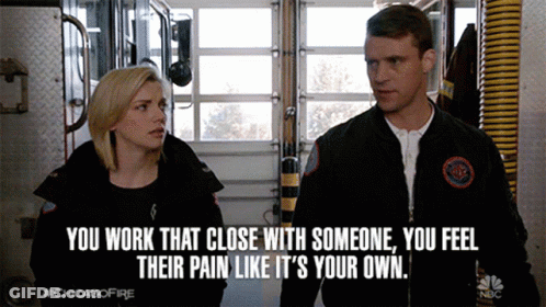 A Man And A Woman Are Standing Next To Each Other With A Caption That Says " You Work That Close With Someone " GIF