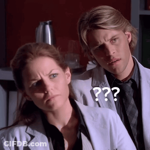 A Man And A Woman Are Standing Next To Each Other With A Question Mark On The Man 'S Jacket GIF
