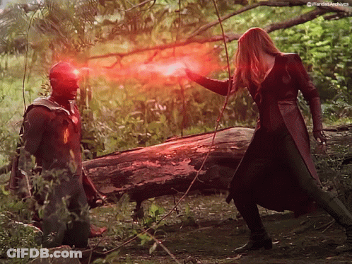 A Man And A Woman Are Standing Next To Each Other With A Red Light Coming Out Of Their Eyes . GIF